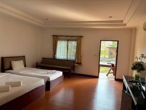 a hotel room with two beds and a balcony at Mireya Resort Khaoyai in Ban Khanong Phra Nua +53 photos