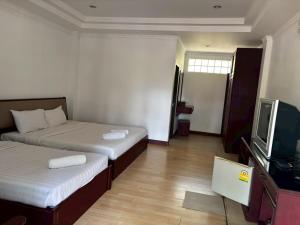 a hotel room with two beds and a television at Mireya Resort Khaoyai in Ban Khanong Phra Nua