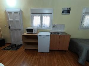 a small kitchen with a sink and a microwave at Habitación independiente en Casa Rural Javier in Valmuel