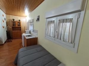 a room with a bed and a sink in it at Habitación independiente en Casa Rural Javier in Valmuel