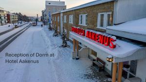 Eine schneebedeckte Stadtstraße mit einem Hotelia-Schild in der Unterkunft Dorm Hilli3 in Rovaniemi