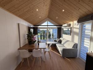 a living room with a couch and a table at Bear Camp Kamionna in Kamionna