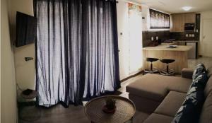 a living room with a couch and a table at Memoirs in Cape Town in Zeekoevlei