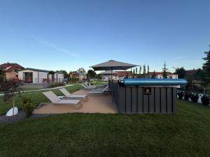 a pool with chairs and an umbrella in a yard at Bear Camp Kamionna in Kamionna