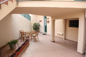 a patio with a table and chairs on it at In Centro Holiday Home in Matera