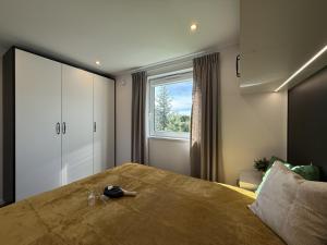 a bedroom with a large bed and a window at Bear Camp Kamionna in Kamionna +53 photos