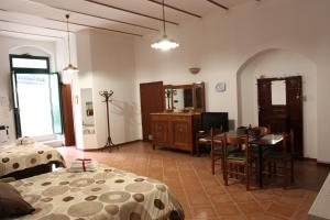 a bedroom with a bed and a table and a dining room at In Centro Holiday Home in Matera