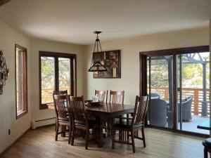a dining room with a wooden table and chairs at Bayou Hills BnB in Parker