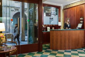 una mujer sentada en un bar en un restaurante en Hotel Rua Villar en Santiago de Compostela