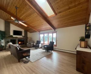 a living room with a vaulted ceiling with wooden ceilings at Bayou Hills BnB in Parker