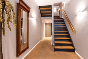 a hallway with a staircase and a mirror at Woge2 Appartement 7 in Borkum