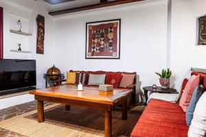 a living room with a table and a couch at The Retreat in Ierapetra