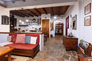 a living room with a couch and a kitchen at The Retreat in Ierapetra