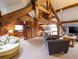 a large living room with wooden walls and beams at Millers Loft in Llanrwst