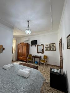 a bedroom with a bed and a living room at Le Camere dei Magi in Saturnia