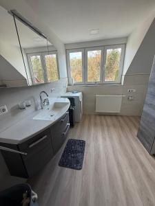 a large bathroom with a sink and a mirror at Ferienhaus Hirschi in Eisenach +32 photos