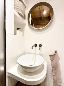 a bathroom with a white sink and a mirror at Casa do Alva in Castelo de Vide
