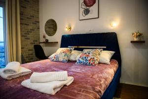 a bedroom with a bed with towels on it at Kuća za odmor Aria in Krapina