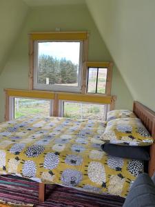 a bedroom with a bed and a window at Sterlochy Cabin in Lochcarron