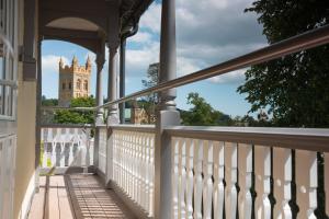 a porch of a house with a tower in the background at Northgate House in Buckfastleigh