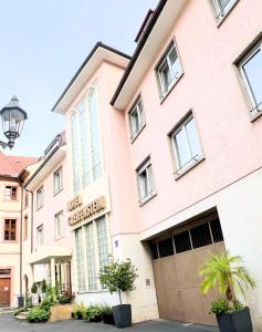 a large pink building with a garage at Greifensteiner Hof in Würzburg