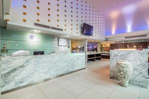 a lobby of a hotel with a large marble counter at Hotel Solo, Sukhumvit 2, Bangkok - SHA Extra Plus in Bangkok