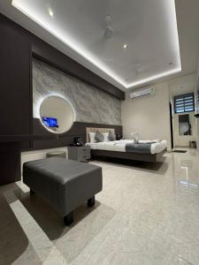 a large bedroom with a bed and a large mirror at Hotel Govind Regency in Dhule +67 photos