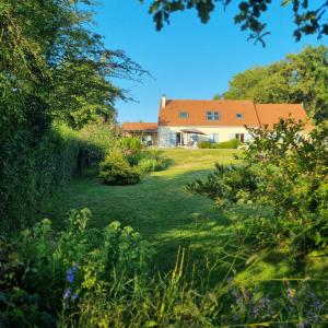 a view of a house from the garden at Parfums des peintres proche Crozant - Chambres d'hôtes in Villard