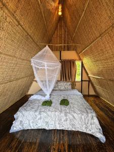 a bedroom with a bed with a net at Sea PoeTree in Koh Rong Sanloem