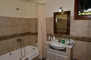 ein Badezimmer mit Waschbecken, Badewanne und Spiegel in der Unterkunft Stolios Skopelos - Panoramic Seaview Gems in Skopelos + 71 Fotos