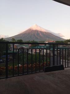 a view of a mountain behind a fence at Witty Woods Guesthouse in Camalig