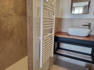 a bathroom with a sink and a mirror at Domaine des Granges in La Bâtie-Montgascon