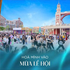 a group of people dancing in front of the eiffel tower at Thanh hoa HOMESTAY in Hòa Bình