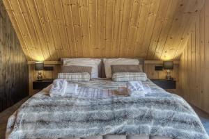 a bedroom with a large bed with two pillows at RzepiskaView in Rzepiska +20 photos