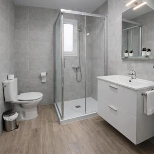 a bathroom with a shower and a toilet and a sink at Casa Pepe La Rosa in Tolox +12 photos