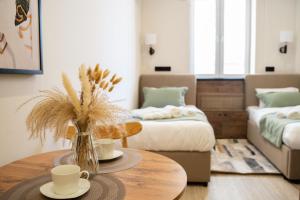 a living room with a table and two beds at Sea Star Boutique Hotel in Almaty