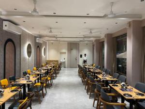 a row of tables and chairs in a restaurant at Hotel Govind Regency in Dhule