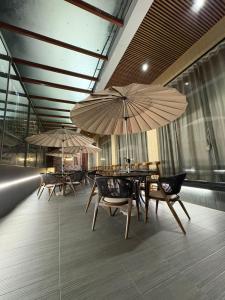 a restaurant with tables and chairs with umbrellas at Hotel Govind Regency in Dhule