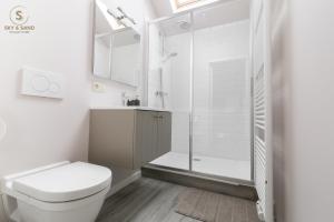 a white bathroom with a toilet and a shower at Sky & Sand - Free parking - Free bikes - EVcharging in Bruges