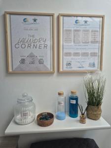 a shelf with two pictures on the wall and some items at Proteas Mare Suites in Protaras +74 photos
