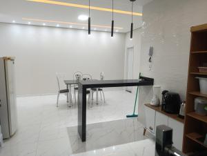 a dining room with a black table and chairs at SSP Ubajara in Ubajara