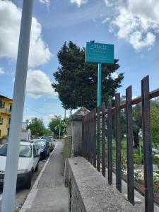 a sign on a fence next to a street at beb san Nicola in Ortueri