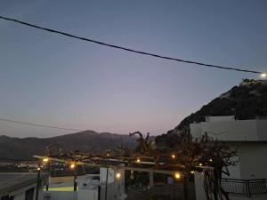 a view of a city at night with mountains at Klima in Vrísai