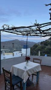 a table and chairs with a table and an umbrella at Klima in Vrísai