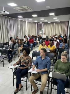 a group of people sitting in chairs in a room at Minas Garden Hotel in Poços de Caldas