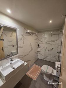 a bathroom with a sink and a toilet and a shower at Panorama in Monemvasia +19 photos