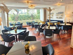 a restaurant with tables and chairs and a large window at Hotel Boutique Palacio del Moral in Ronda +27 photos