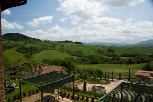 a view of the rolling hills from a house at Spa Resort Fonte Alla Lepre in Riparbella