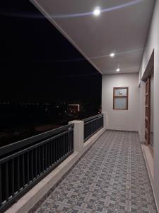a balcony with a view of the city at night at Hacienda napoles in Chandigarh Airport