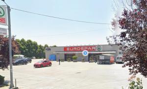 a store with a car parked in a parking lot at B apartments 2 in Case Bruciate